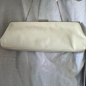 Hype cream or off white clutch with rhinestones and silver chain strap.